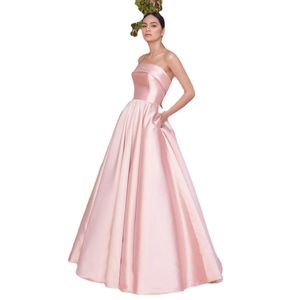 Elegant pink satin strapless floor-length evening gown with pockets and a full skirt