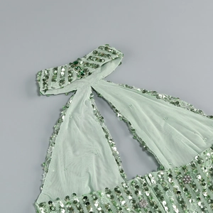 Detail of mint green sequins and mesh fabric on a halter neck sleeveless dress