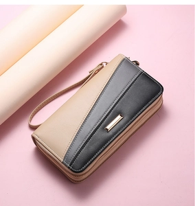 Detail view of long tricolor patchwork wallet with dual zippers and detachable wrist strap