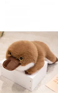 Close-up of plush platypus toy with soft brown fur on a white display stand