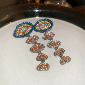 Makroaufnahme von Vintage-Silberohrringen mit bunten Strasssteinen und Sterneneffekt