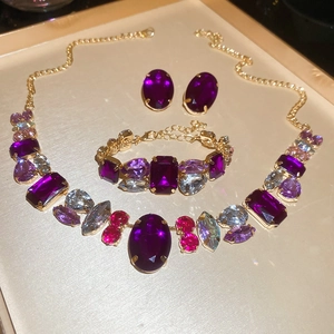 Detailed view of the jewelry set with purple gemstones and gold-plated vintage chains