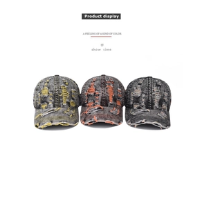 Detailed close-up of distressed denim baseball caps with vintage rips and frayed edges