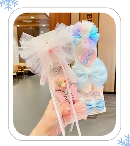 Detail of girls Frozen themed hair bow set featuring pink mesh and unicorn clips