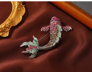 Macro shot of colorful rhinestones on a carp brooch with high-end velvet background