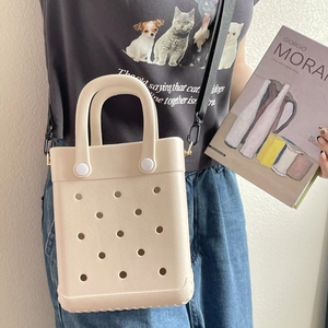 Detail of beige EVA tote bag with ventilation holes and adjustable black shoulder strap