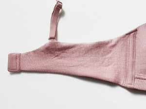 Detail view showing mauve ribbed knit fabric and adjustable straps of the bralette