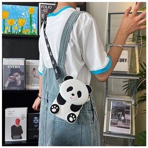 Close-up of a cute panda silicone crossbody bag with printed strap worn by a child