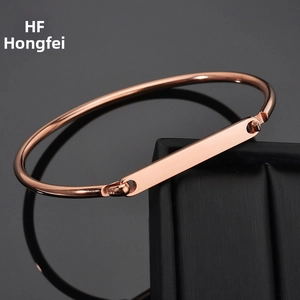Detailed macro view of a rose gold vacuum plated minimalist bangle with rectangular bar
