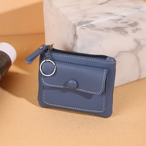 Blue PU leather mini coin purse with zipper and keyring displayed on marble block