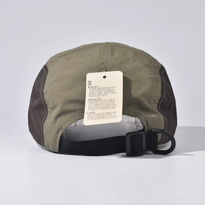 Detail of adjustable strap and D-ring on a two-tone olive green and brown 5-panel outdoor cap