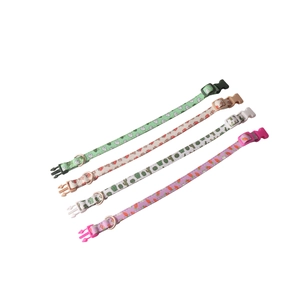 Colorful pet collars with fruit and plant patterns including strawberries and cacti