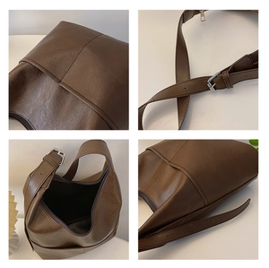 Detail of dark brown hobo bag showing pebbled leather texture and adjustable strap buckle