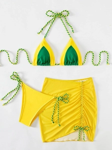 Detailed flat lay of three-piece yellow and green bikini set with drawstring skirt
