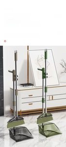 Close-up of translucent dustpan and long-handle broom set with stainless steel poles