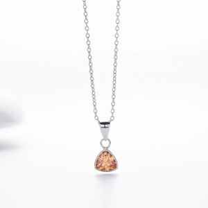 Detail of minimalist S925 silver necklace with a triangular champagne gemstone pendant