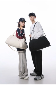 Large capacity travel gym bags in black and cream shown on male and female models
