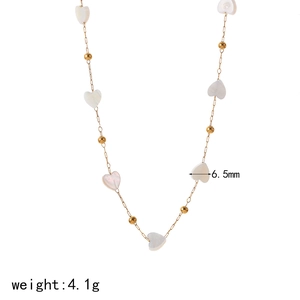 Detail of 18k gold chain with 6.5mm white heart pendant and beads, weighing 4.1g