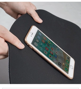 Flexible black diatom mud mat being bent to show high elasticity and soft texture