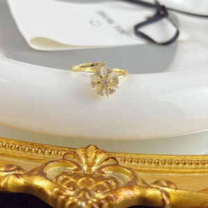 Rotating cat-eye flower ring in gold finish with white petals and clear zircon accents