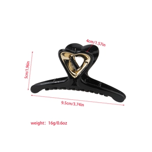 Glossy black hair claw clip with golden heart detail and size measurements