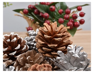 Macro detail of natural pine cone ornaments in gold, silver and white for Christmas tree decor