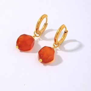 Geometric gold hoop earrings featuring irregular red natural stone charms in a modern style