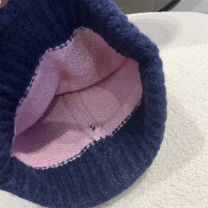 Detailed close-up of thick knitted wool lining and two-tone texture for winter hat