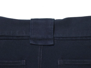 Dettaglio dei pantaloni cargo blu scuro con passanti per cintura e doppie cuciture