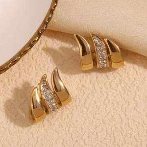 Close-up of 18K gold plated flag curve earrings with zircon inlay on silk and ceramic