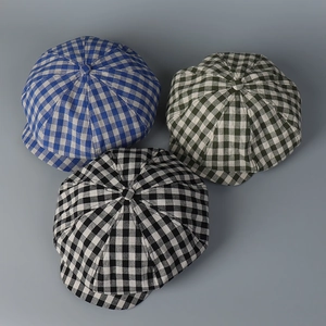 Top view of three linen gingham newsboy caps in blue, green, and black check patterns