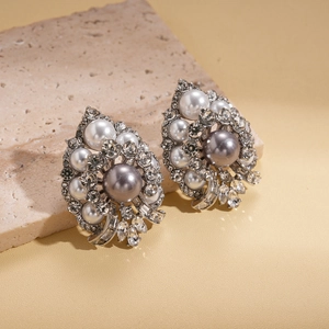 Detailed macro of vintage silver stud earrings with grey faux pearl and sparkling rhinestones