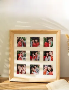 Detail of solid wood 9-grid photo frame with bevelled edge design and natural leaf shadows