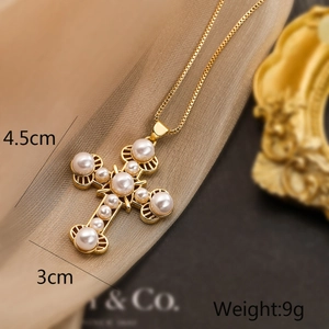 Macro shot showing dimensions of gold-plated cross necklace with pearls and zircons