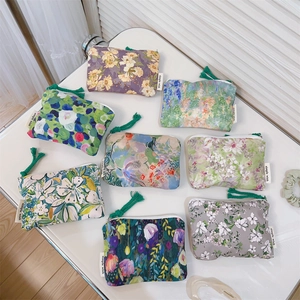 Detailed view of floral canvas mini pouches with colorful tassels and simple wish label