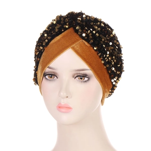 Ginger and black velvet turban headwear with golden sequins shown on a mannequin head