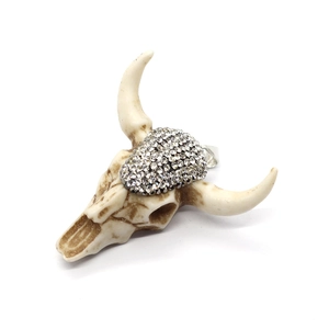 Exquisite resin bull head skull pendant with silver rhinestones on a white background