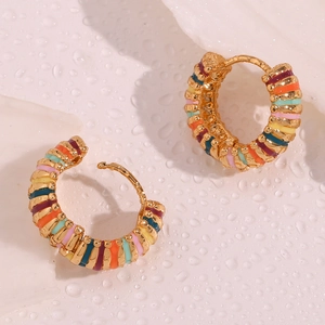 Macro detail of 18K gold plated hoop earrings with vibrant colorful enamel stripes