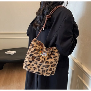 Detail of leopard faux fur shoulder bag with cartoon embroidery and thin cord strap
