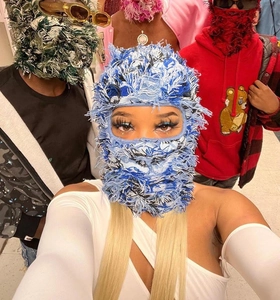 Group of models wearing colorful fringed knitted balaclavas with street style design