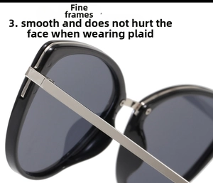 Detail of metal hinge and temple joining the glossy black cat-eye sunglasses frame