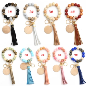 Nine colorful silicone bead keychain sets with checkerboard patterns and leather tassels