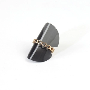 Golden hollow chain ring with oval link design displayed on a sleek black jewelry stand