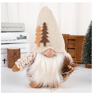 Detail of Christmas gnome with beige knitted hat and decorative pine tree bag on wood