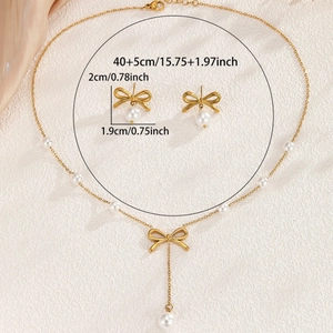 Elegant gold bow necklace and earring set with pearls on a luxurious silk background