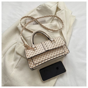 Top view of beige geometric print handbag with round handle on a cream blazer background