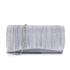 Detail of silver pleated evening clutch bag with sparkling texture and metal chain strap
