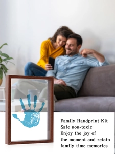Detail of DIY handprint kit in dark wood frame with safe, non-toxic blue palm prints