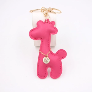 Macro detail of rose red PU leather giraffe keychain with gold With Love engraving