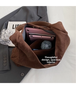 Macro shot of brown suede tote bag interior with large capacity for laptop and daily items